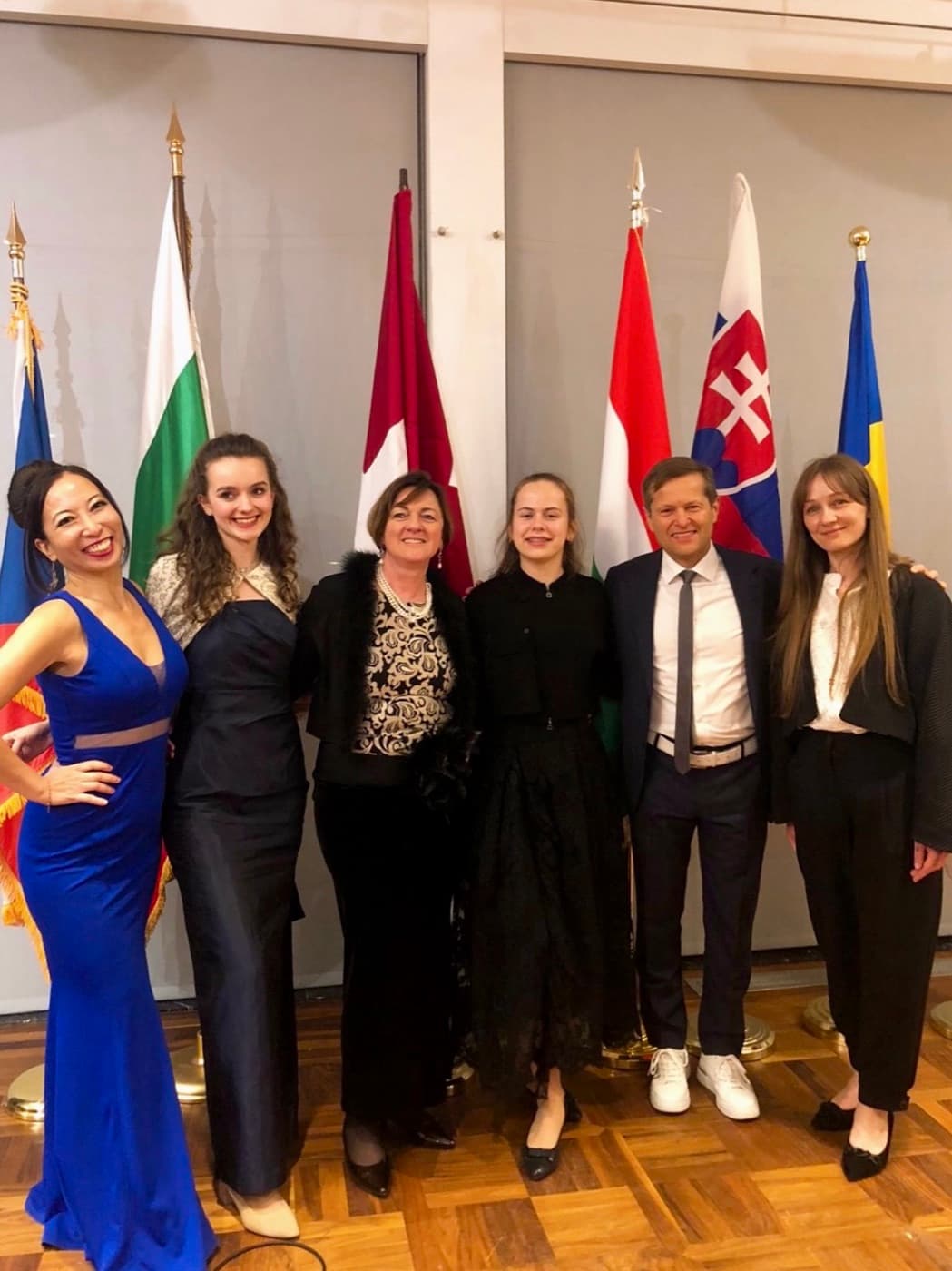 Annamaria with the former ambassador and colleagues in front of Central European flags