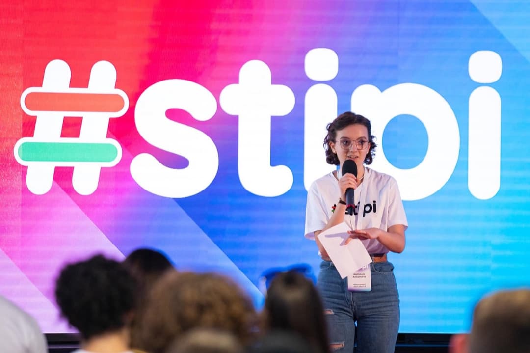 Annamaria speaking on stage at a Stipendium scholarship event