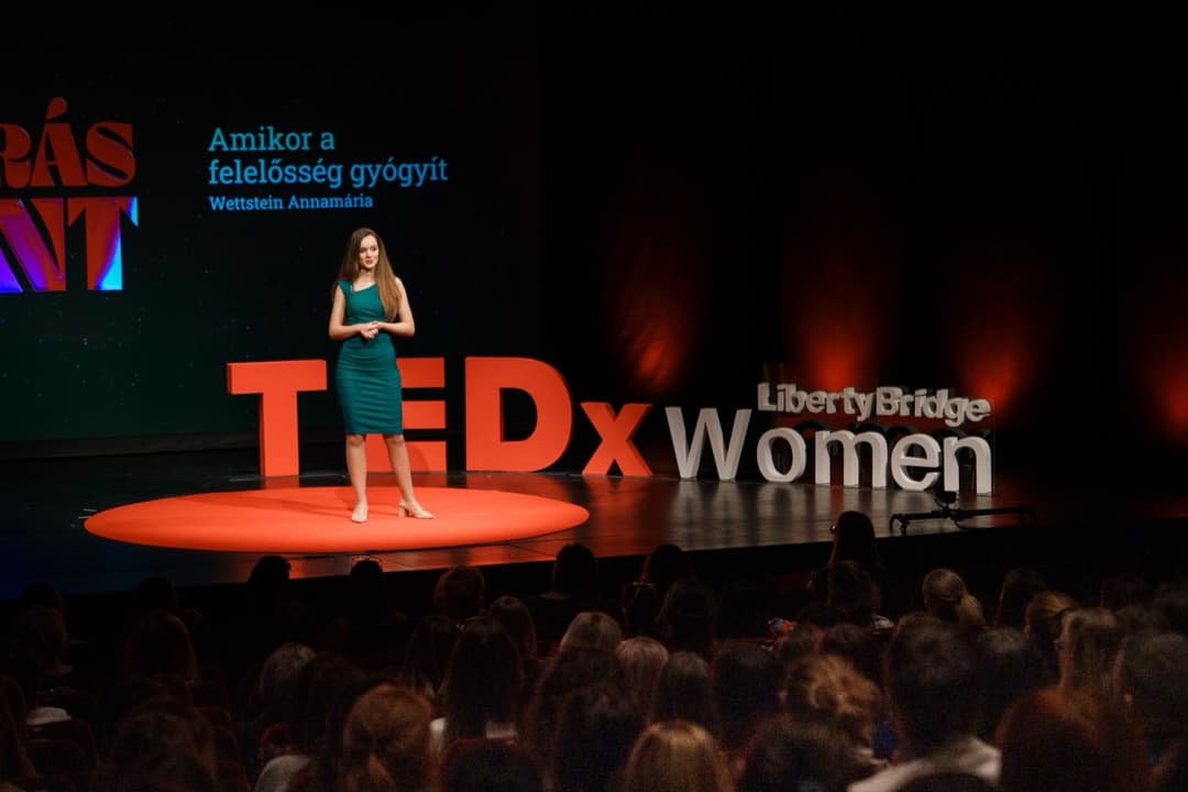 Annamaria giving a TEDx talk on stage